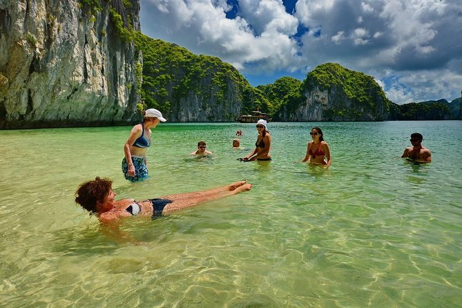 1 Day Boat Tour: HaLong Bay, Lan Ha Bay, Natural Beach and Full Moon Party - Stop 3 in Hạ Long Bay: Jump-In Swimming and Natural Caves