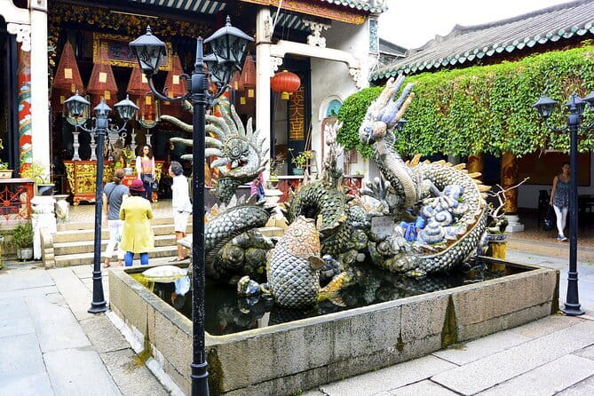 Explore Hoi An Ancient Town and Coconut Village with Dinner - Walking into Hoi An Old Town: assembly hall, merchant houses, and a bridge