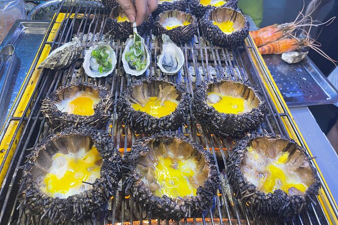 Saigon By Night and Street Food By Motorbike | Opt: Ao Dai Riders - Stop 2 in District 10: Flower market food with grilled oysters and quail eggs